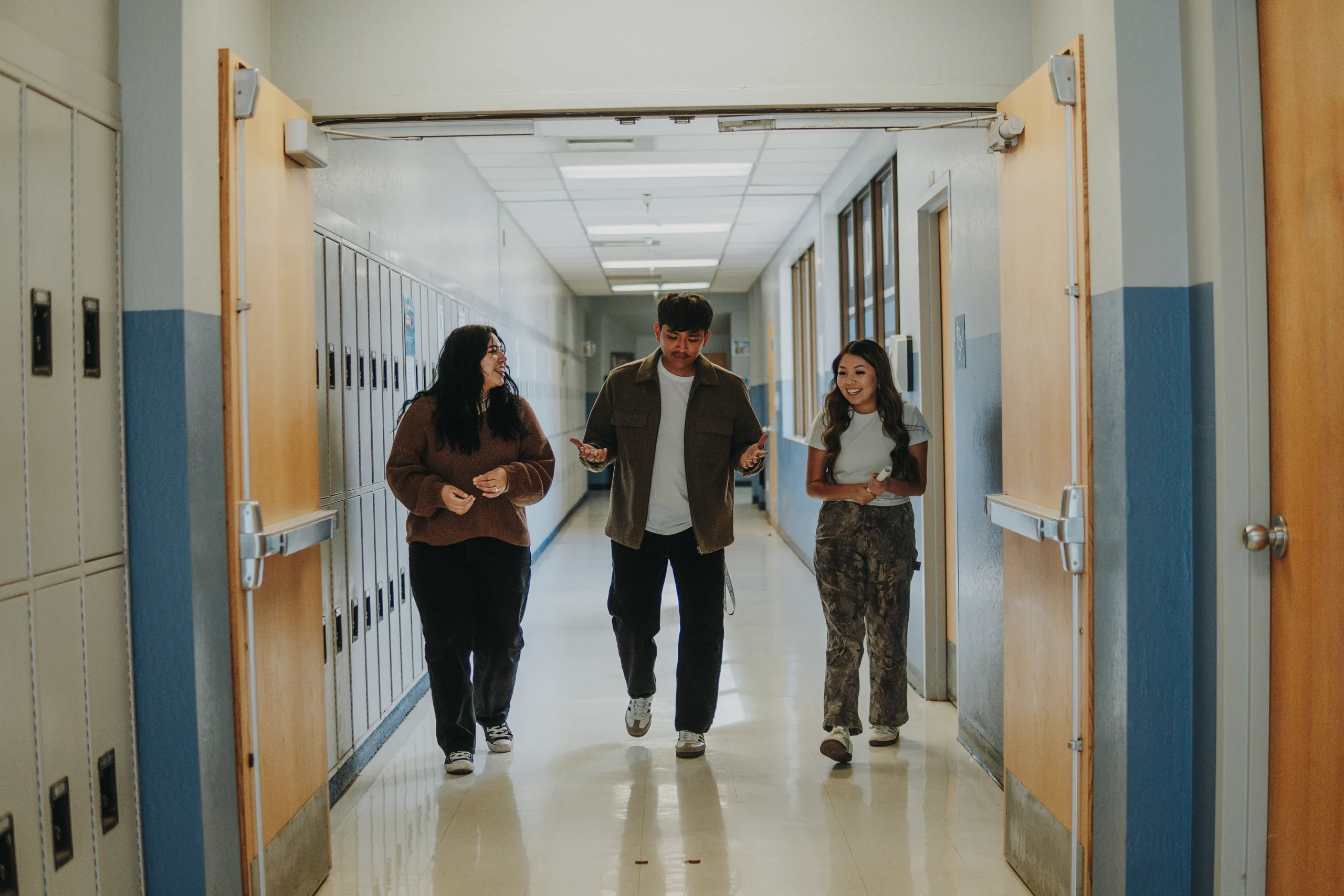 Elevate students walking through a school hallway